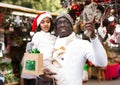 Man with small daughter looking around at Christmas fair Royalty Free Stock Photo