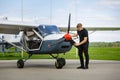 Young man in small plane cockpit outdoors Royalty Free Stock Photo