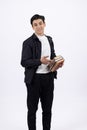 Young man in smart casual outfit holding stack of books. Royalty Free Stock Photo