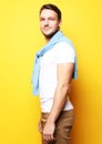 young man in smart casual wear looking at camera over yellow bac Royalty Free Stock Photo