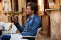 Young man with smartphone in an cafe outdoor Royalty Free Stock Photo