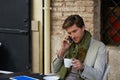 Young man with smartphone in an cafe outdoor Royalty Free Stock Photo