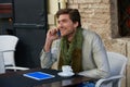 Young man with smartphone in an cafe outdoor Royalty Free Stock Photo