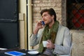 Young man with smartphone in an cafe outdoor Royalty Free Stock Photo