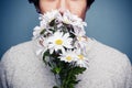 Young man smelling a bouquet of flowers