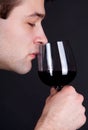 Young Man smelling a glass of red wine Royalty Free Stock Photo