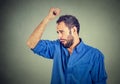 Young man, smelling, sniffing his armpit, something stinks, very bad, foul odor Royalty Free Stock Photo
