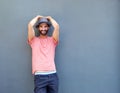 Young man smiling against gray background with hat Royalty Free Stock Photo