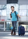 Young man smiling with bags at airport Royalty Free Stock Photo