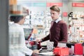 Young man smiling while buying an useful pharmaceutical product