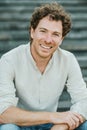 Young man smiling on camera outdoor in the city - Focus on face Royalty Free Stock Photo