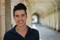 Photo of a young man with a bright smile. A cheerful young adult smiling with eye contact.