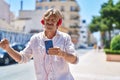 Young man smiling confident listening to music and dancing at street Royalty Free Stock Photo