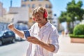 Young man smiling confident listening to music and dancing at street Royalty Free Stock Photo