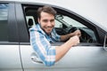 Young man smiling and driving Royalty Free Stock Photo