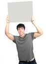 Young man smiling and holding sign Royalty Free Stock Photo