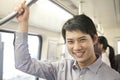 Young man smiling and looking at camera in subway Royalty Free Stock Photo