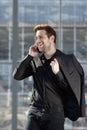 Young man smiling with mobile phone in the city Royalty Free Stock Photo