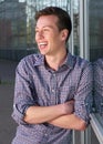 Young man smiling outdoors with arms crossed Royalty Free Stock Photo