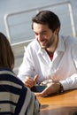 Young man smiling and showing woman mobile phone