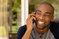 Young man smiling while talking on mobile phone Royalty Free Stock Photo