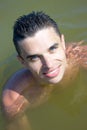 Young man smiling in the water