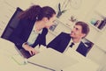 Young man and smiling woman coworkers talking in firm office Royalty Free Stock Photo