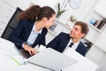 Young man and smiling woman coworkers talking in firm office Royalty Free Stock Photo