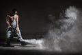 Young man with a smoke machine