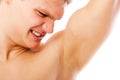 Young man sniffing his armpit