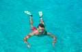 Young man snorkeling in clear tropical turquoise Royalty Free Stock Photo