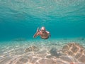 Young man snorkeling in crystal clear waters