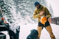 Young man in the snow forest shake off snow from helmet