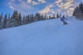 Young man snowboarder running down the slope in Karakol mountains. Royalty Free Stock Photo