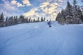 Young man snowboarder running down the slope in Karakol mountains. Royalty Free Stock Photo