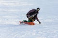 Young man snowboarding down the piste Royalty Free Stock Photo