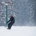 Young man snowboarding down a slope