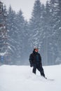 Young man snowboarding down a slope