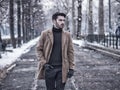 Young man in snowy city