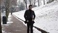 Young man in snowy city park