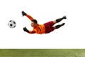 Young man, soccer football goalkeeper catches ball in jump isolated over white background. Concept of sport, action Royalty Free Stock Photo