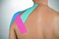 Young man with some strips of elastic therapeutic tape in his ba