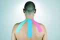 Young man with some strips of elastic therapeutic tape in his ba