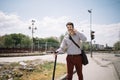 Young man speaking on the phone while walking with electric scooter Royalty Free Stock Photo