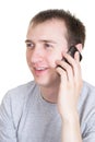 The young man speaks by a mobile phone, isolated Royalty Free Stock Photo