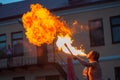 A young man spews a fire out of his mouththe young man spews fire from his mouth. spectacle for visitors Royalty Free Stock Photo