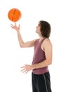 Young man with spinning basketball at his forefinger Royalty Free Stock Photo