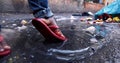 Young man splashing in dirty water in the countryside. Closeup leg`s shot Royalty Free Stock Photo