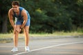 Young man in sportswear having knee problems Royalty Free Stock Photo