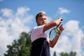 Young man in sportwear is playing tennis on out door court.